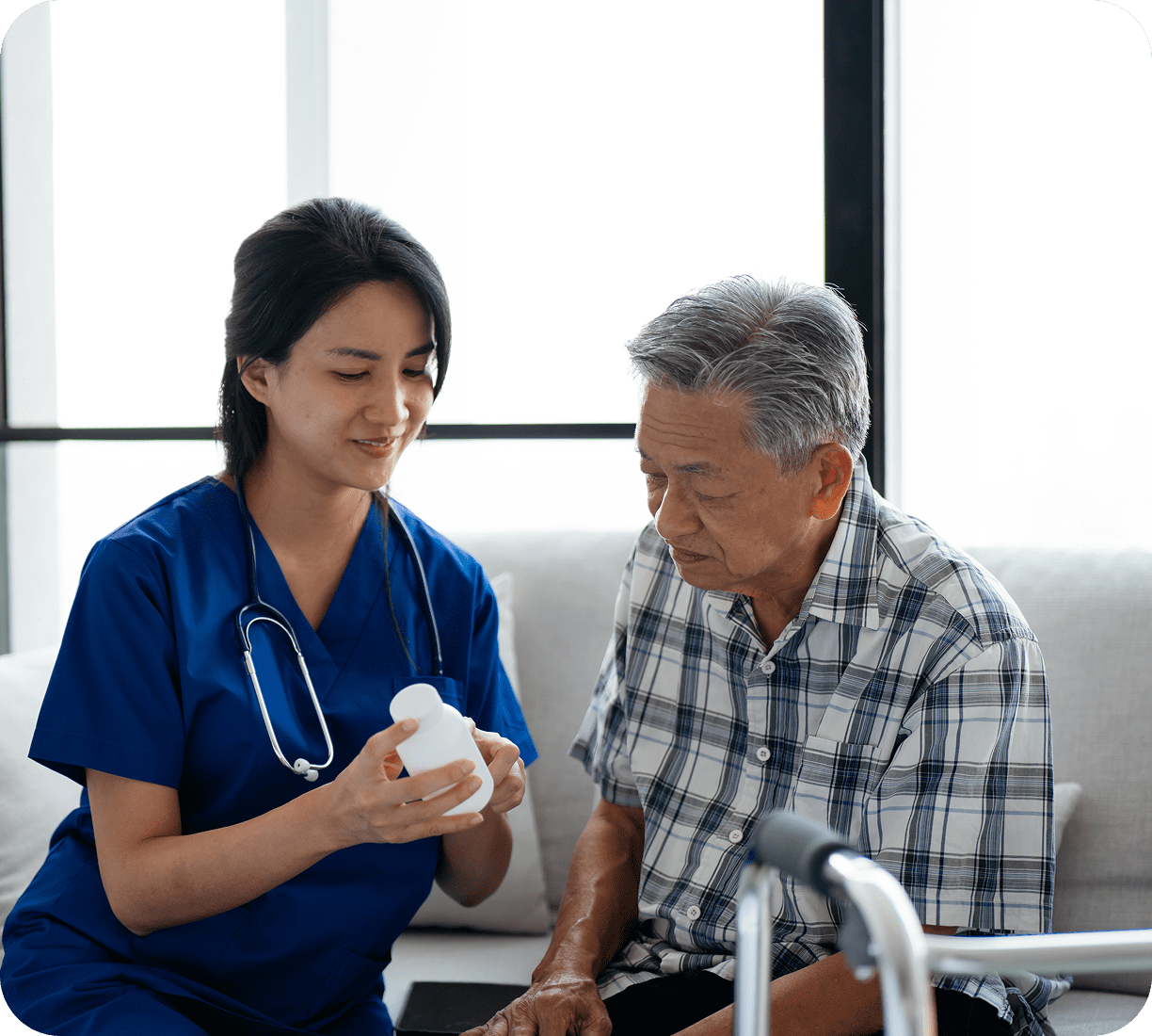 Nurse showing medication to elderly patient
